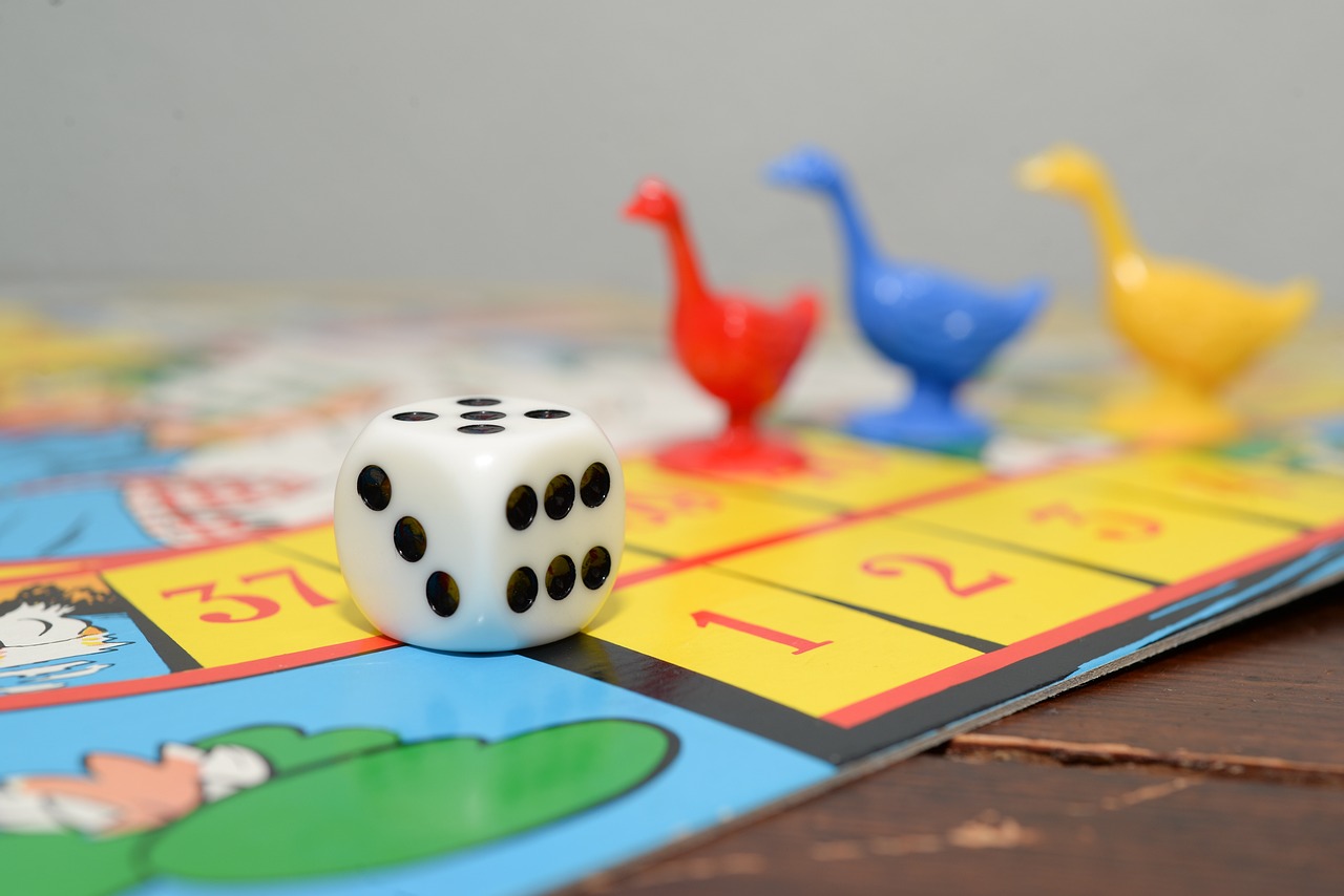 Colorful board game with di and three goose tokens